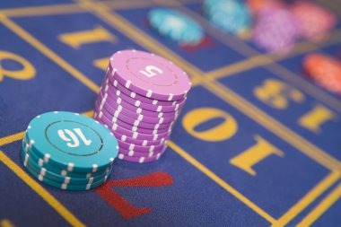 Caishen Wins slot game interface on mobile phone showing reels, bet controls, and balance